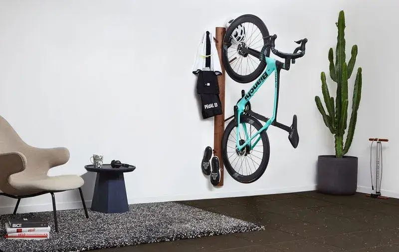 Bike stored vertically on a wall.